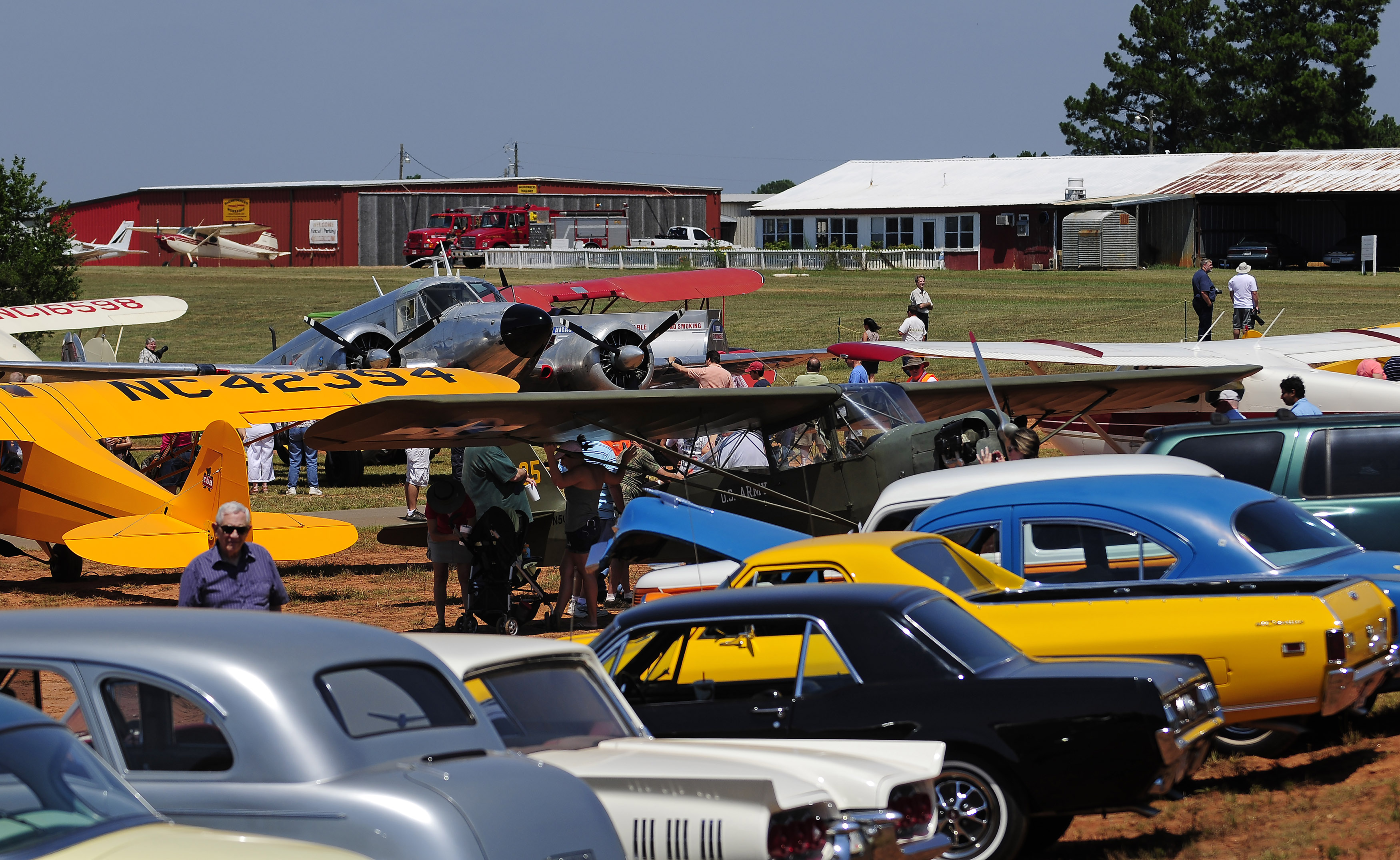 Classic and antique automobiles and airplanes line the ramp at during the 2011 Vintage Day celebration in Williamson, Georgia. Photo by David Tulis.