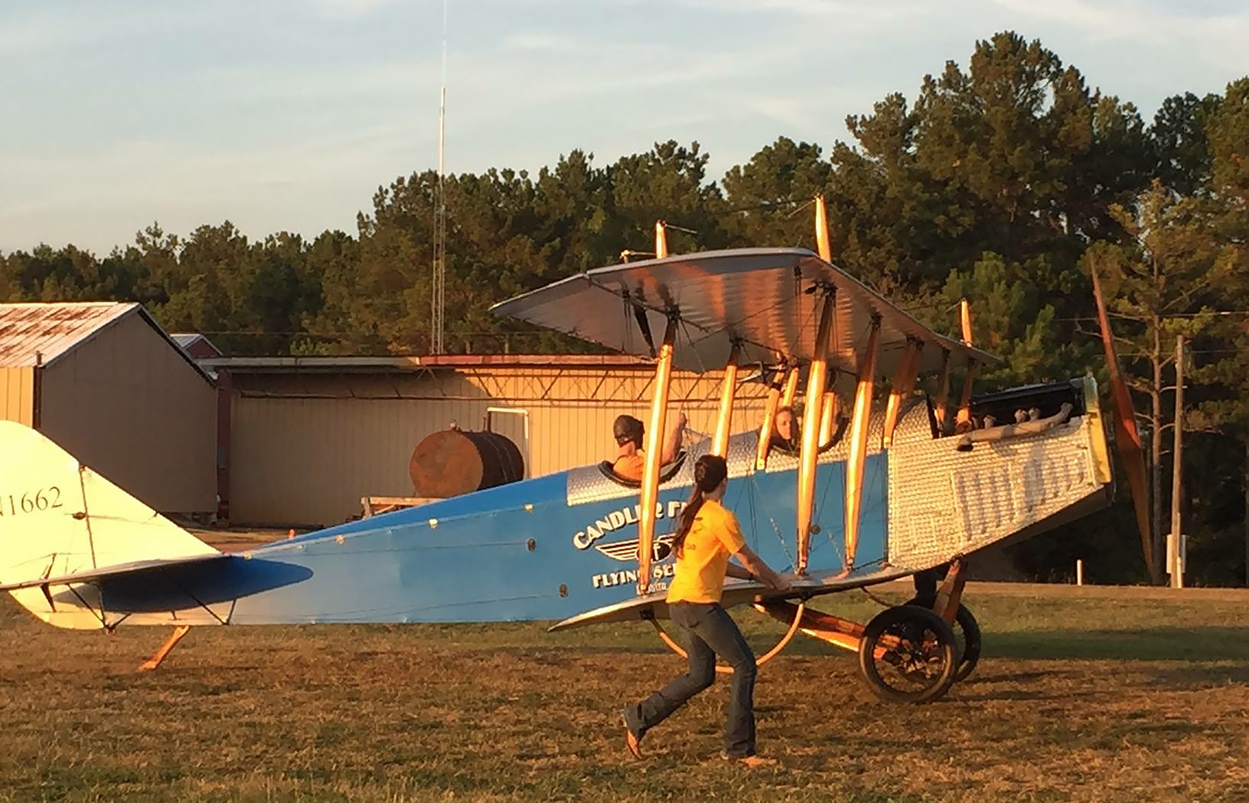 Student pilot Cayla McLeod helps wing walk a Curtiss JN-4 Jenny for Ron Alexander at his Peach State Aerodrome in Williamson, Georgia. Photo courtesy of Cayla McLeod.
