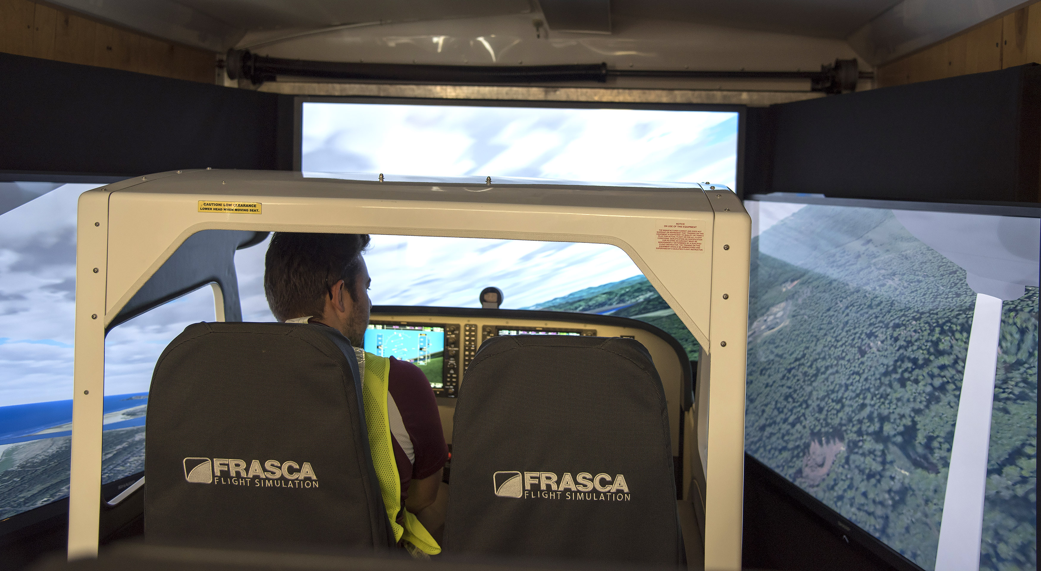 A collegiate aviation student checks out a mobile Frasca flight simulator during the National Intercollegiate Flying Association's National Safety and Flight Evaluation Conference. Photo courtesy of Lisa Ross, Parhelia Multimedia.