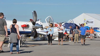 Visitors to AOPA's Tampa Fly-In stroll among the static display aircraft Saturday morning. The event was held at idyllic Peter O. Knight Airport, located on the city's waterfront. Photo by Mike Collins.