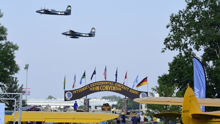 A pair of Grumman F7F Tigercats performs near the Brown Arch during EAA AirVenture at Wittman Regional Airport in Oshkosh, Wisconsin, July 23, 2018. Photo by David Tulis.