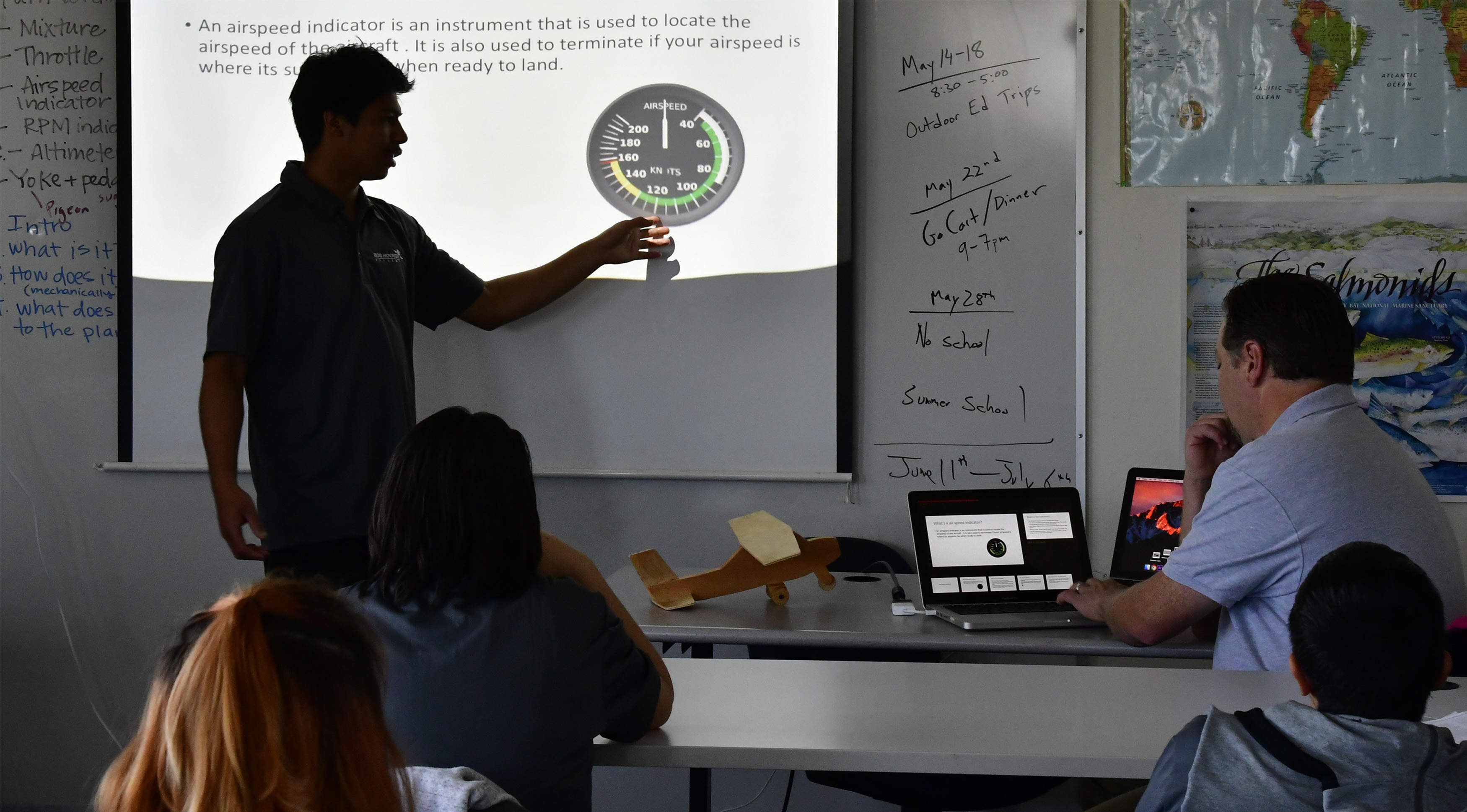 Bob Hoover Academy high school student Diego Merida delivers an in-class presentation on how an airspeed indicator works. Classmates cheered, clapped, and high-fived their peers after the presentations. Photo by David Tulis.