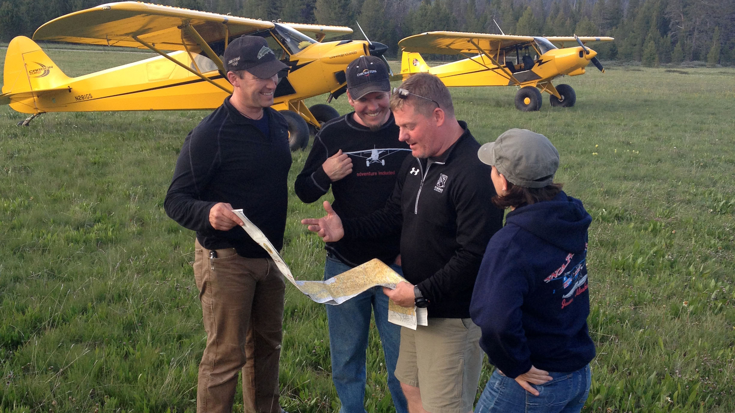 Todd Simmons, pictured second from the right with no hat, gathers with friends at the Sulphur Creek Airstrip several years ago.