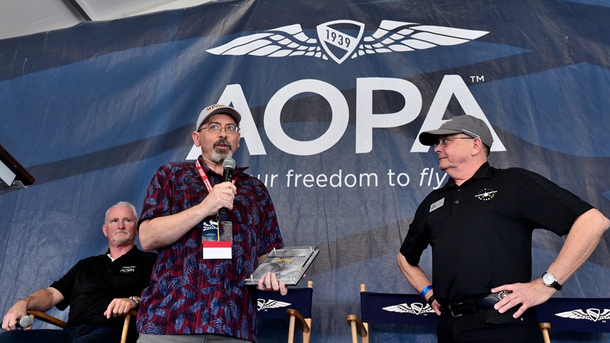 AOPA recognized the Midway Flying Club, located in Texas, as the 100th flying club AOPA helped to launch. Bryan Jakubik, left, the club's secretary, talks with Steve Bateman, director of AOPA's Flying Clubs Initiative, during a Pilot Town Hall at the 2019 Sun 'n Fun International Fly-In and Expo. Photo by Mike Collins.