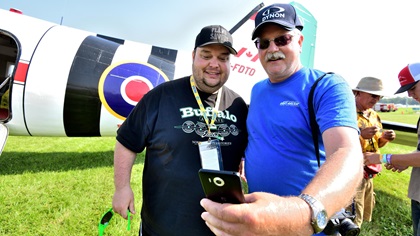 Mikey McBryan, who created the Plane Savers project to restore a historic Canadian DC-3, poses for a selfie with a fan at EAA AirVenture Oshkosh 2019. Photo by Mike Collins.
