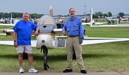 Aerospace engineer Burt Rutan, right, stands next to one of his original designs, the twin-fin VariViggen, which debuted at the airshow in 1972. Rutan has developed dozens of research aircraft during a lengthy aviation design career. Photo by David Tulis.