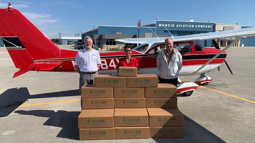 Mursix Vice President of Business Development Susan Murray Carlock delivers face shields produced and donated by her company to Angel Flight East pilots Ed Loxterkamp (left) and Todd Harris for distribution. Photo courtesy of Ed Loxterkamp.