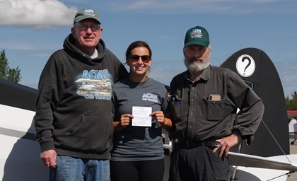 Georgetown University medical student Sarah Powell, center, joins ACME Cub Training instructor Steve Williams, left, and Terry Cartee after she earned her private pilot certificate in 26 days during training in Anchorage, Alaska. Photo courtesy of ACME Cub Training. 