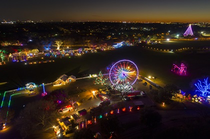 This photo shows the Austin, Texas, Trail of Lights holiday display, with the Zilker Tree in the background, right. The photo was made with the DJI Phantom 4 Pro, about 20 minutes past evening civil twilight. It is a one-second exposure at 200 ISO (to reduce noise) and f 2.8. Photo looks southwest towards the sunset. Photo by Zach Ryall.