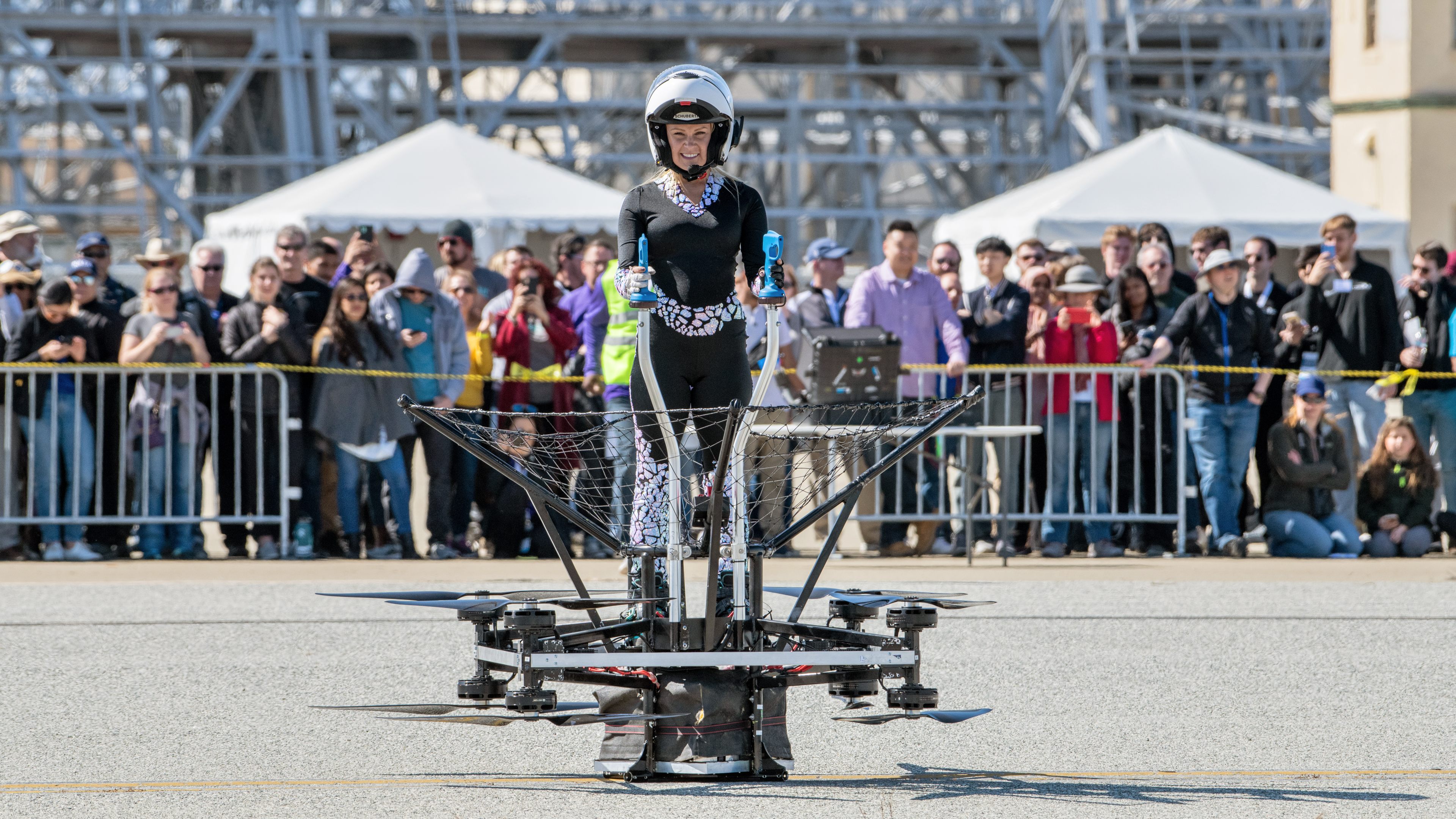Mariah Cain, who leads the DragonAir Aviation team, poses on their Airboard. Damaged in a hard landing earlier in the week, it was repaired but could not compete for the GoFly Prize. Photo by Mike Collins.