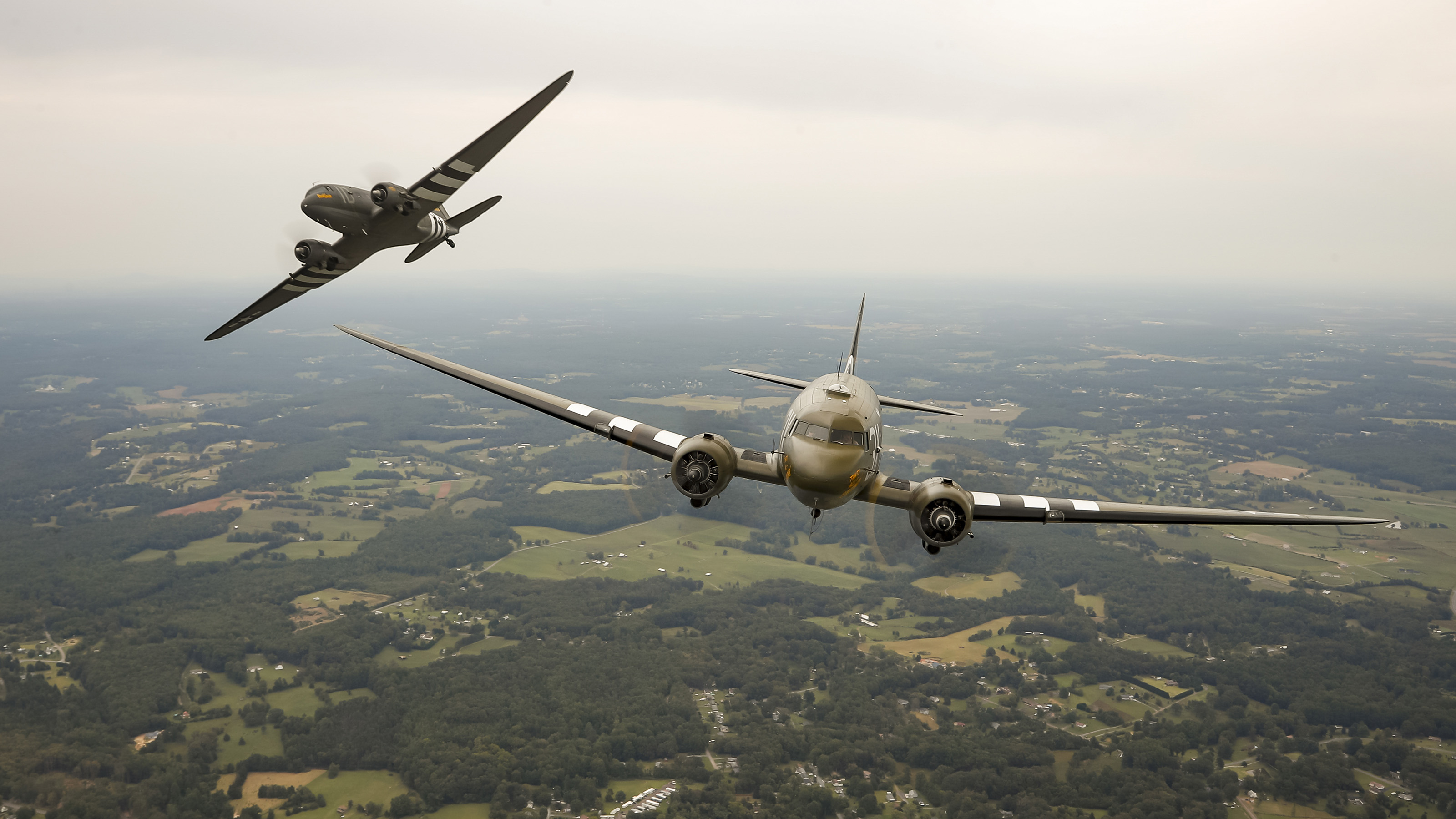 The Douglas C-47 Skytrains "Placid Lassie" and "That's All, Brother" participate in formation practice. Photo by Chris Rose.