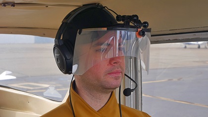 The Icarus device comprises a clear face shield coated with polymer-dispersed liquid-crystal film that can vary its opacity under electronic control. Photo courtesy of Icarus Devices.   