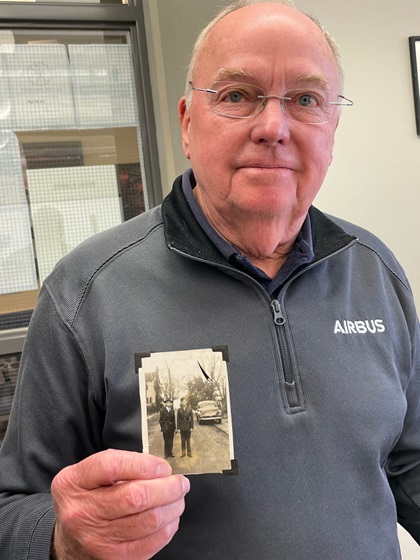 Tom Womack, winner of a B-25 second-in-command type rating course, holds a photo of his father and grandfather taken during World War II. Photo by Tom Haines.