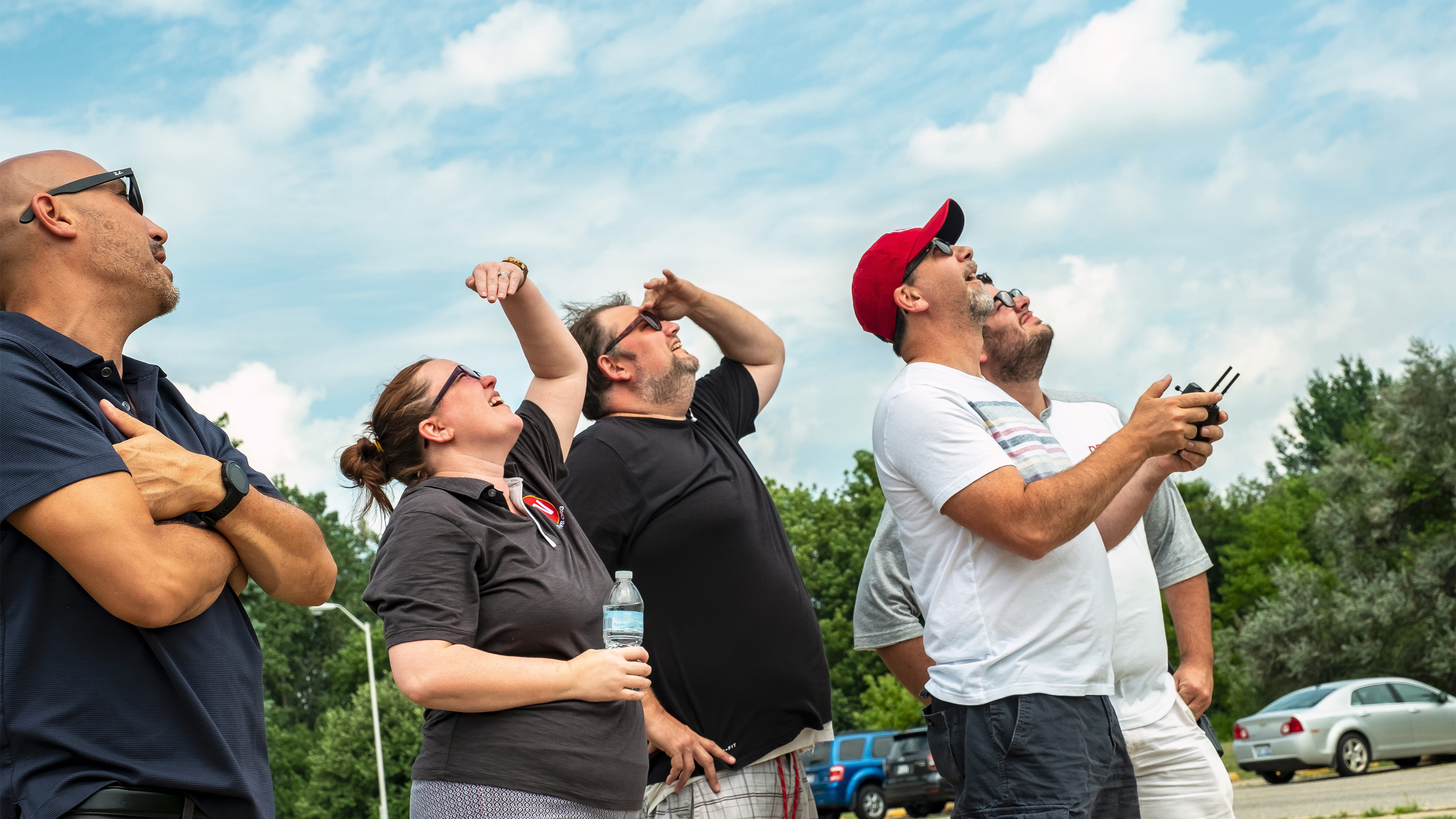 First-time aviators look up after launching their new drone. 