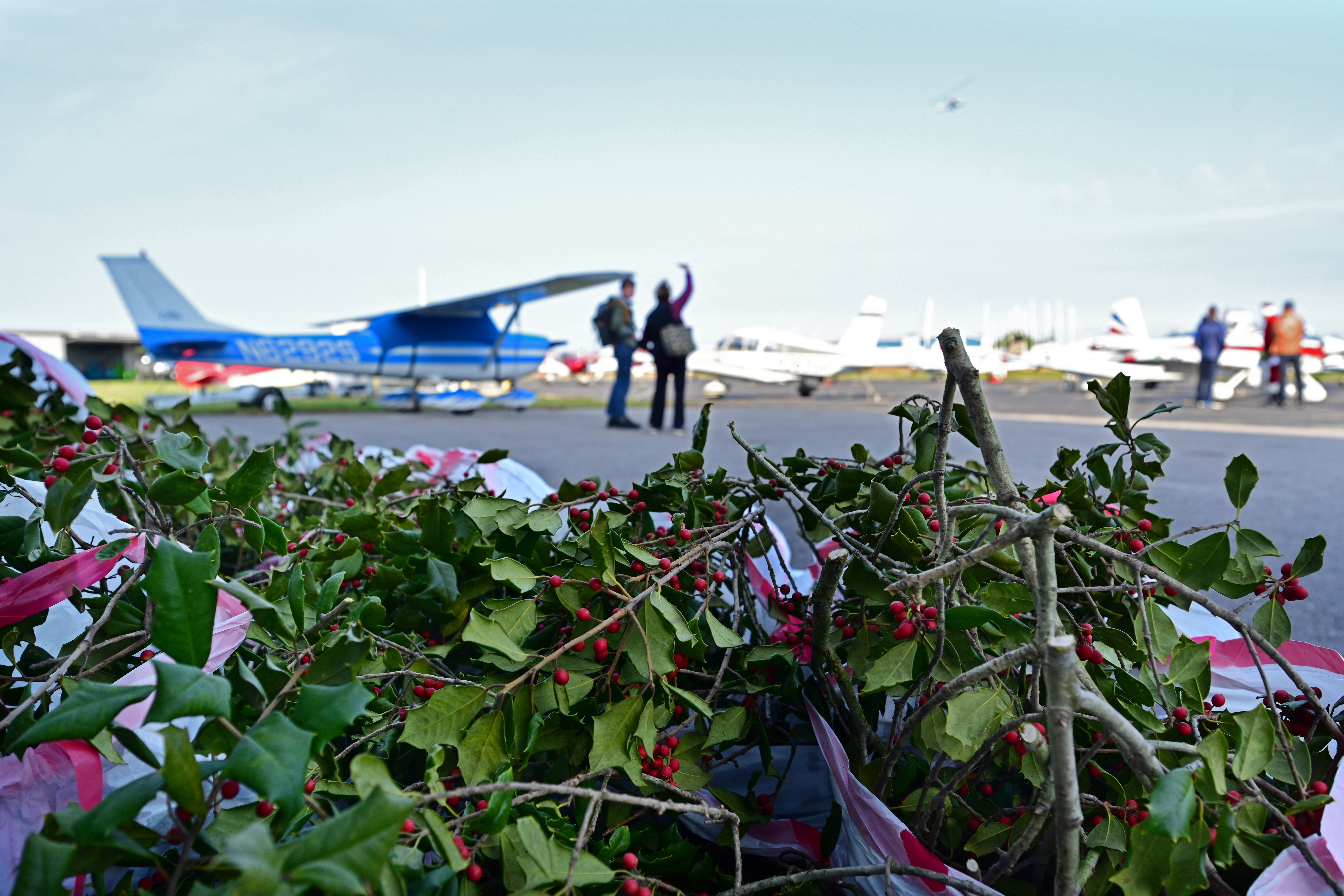 General aviation pilots gather at Bay Bridge Airport in Stevensville, Maryland, to deliver holly branches, school supplies, and holiday presents to 400 residents of Tangier Island, Virginia. Photo by David Tulis.                                                                           