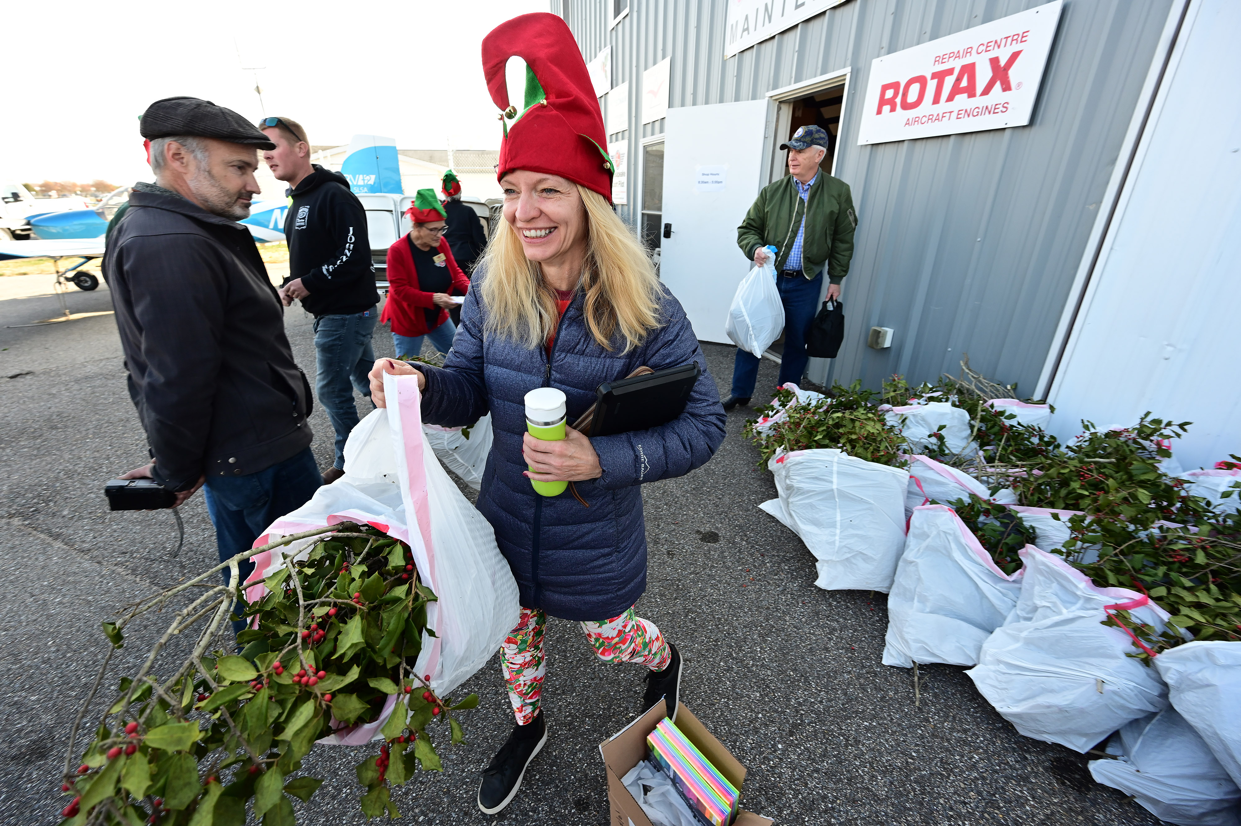 Student pilot Michelle Held helps ferry holly branches, school supplies, and holiday presents to Tangier Island, Virginia, during the annual Holly Run fly-out. Photo by David Tulis.                                                                                                          