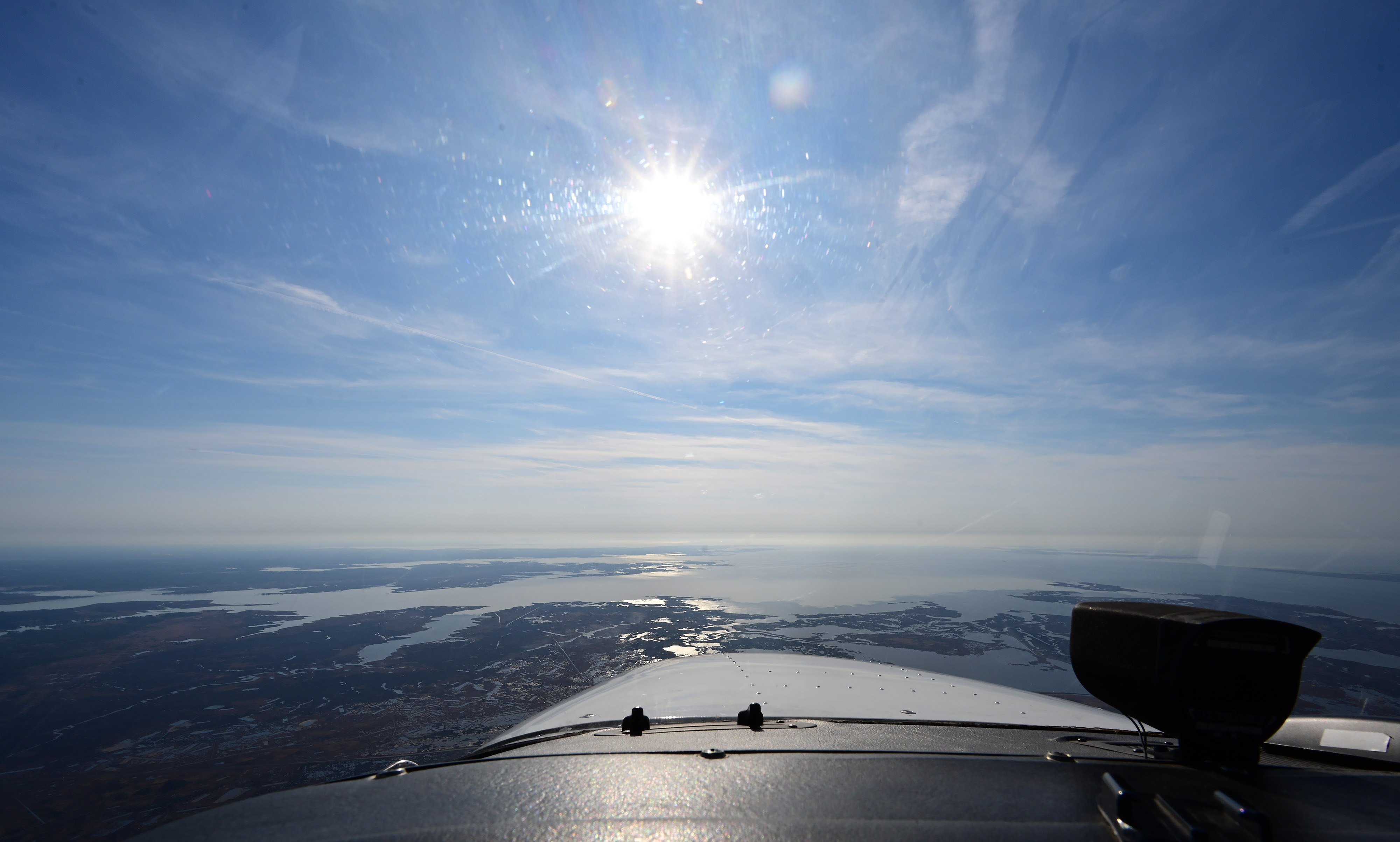 Chesapeake Bay spreads out in front of a Cessna 172 Skyhawk during the annual Holly Run to Tangier Island, Virginia. Photo by David Tulis.                                                                                                                                                     