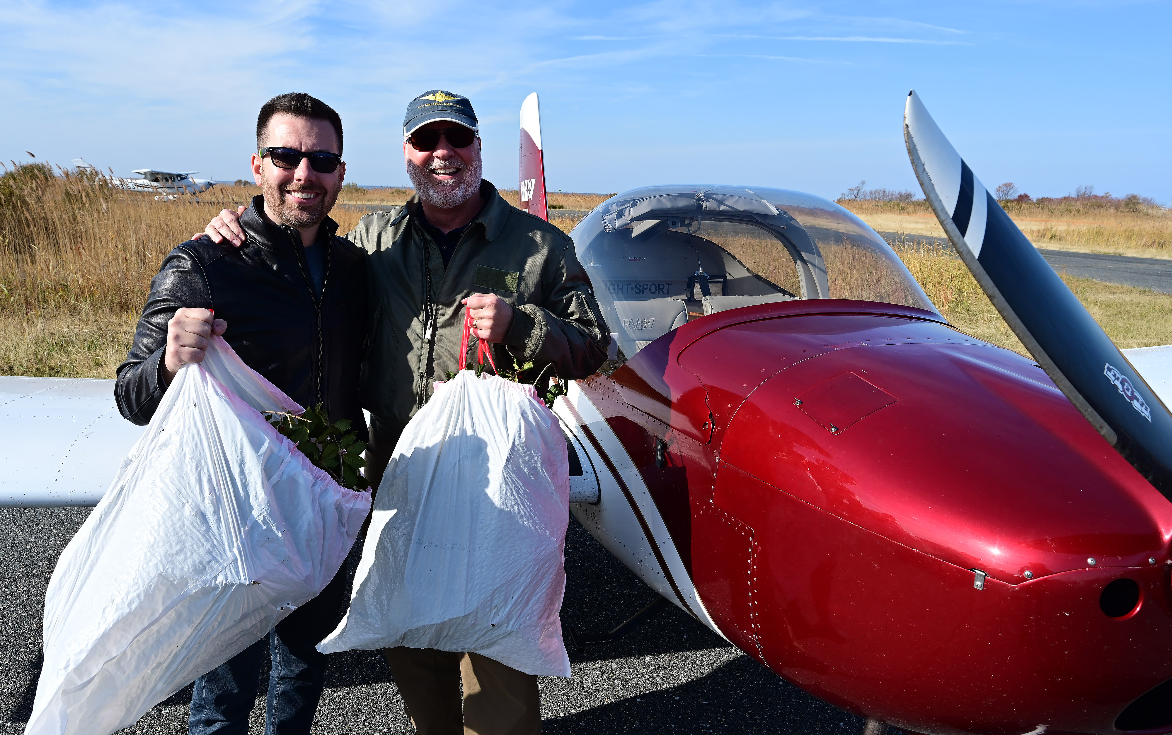 Pilots help deliver holly branches, school supplies, and holiday presents to Tangier Island, Virginia. Photo by David Tulis.                                                                                                                                                                    