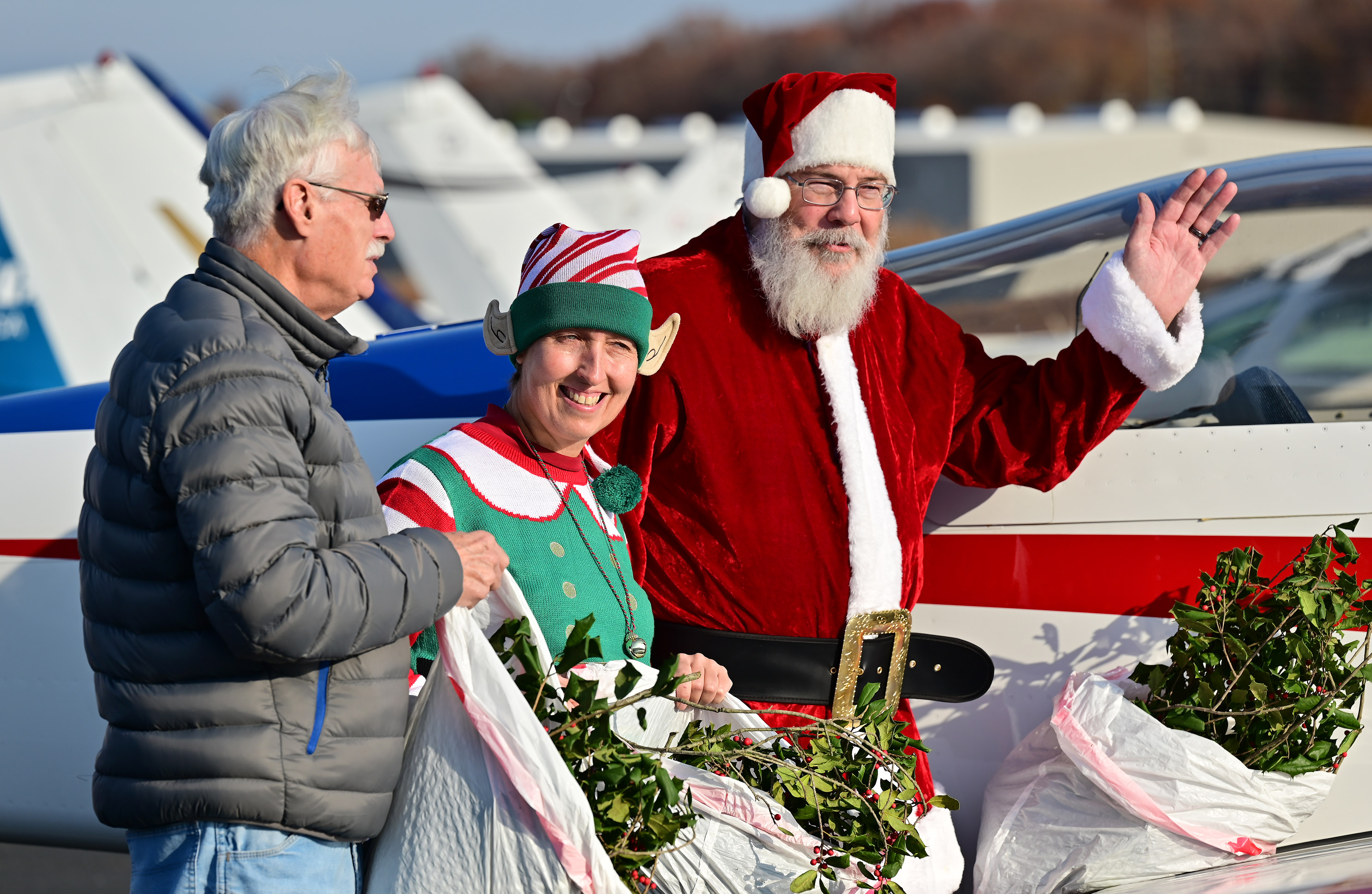 Ed Nabb Jr., who’s father began the annual Holly Run tradition in an Ercoupe in 1968, joins Helen Woods of Chesapeake Sport Pilot and Santa Claus Ralph Hoover to deliver holly branches, school supplies, and holiday presents to residents of Tangier island, Virginia, in the Chesapeake Bay. Photo by David Tulis.
