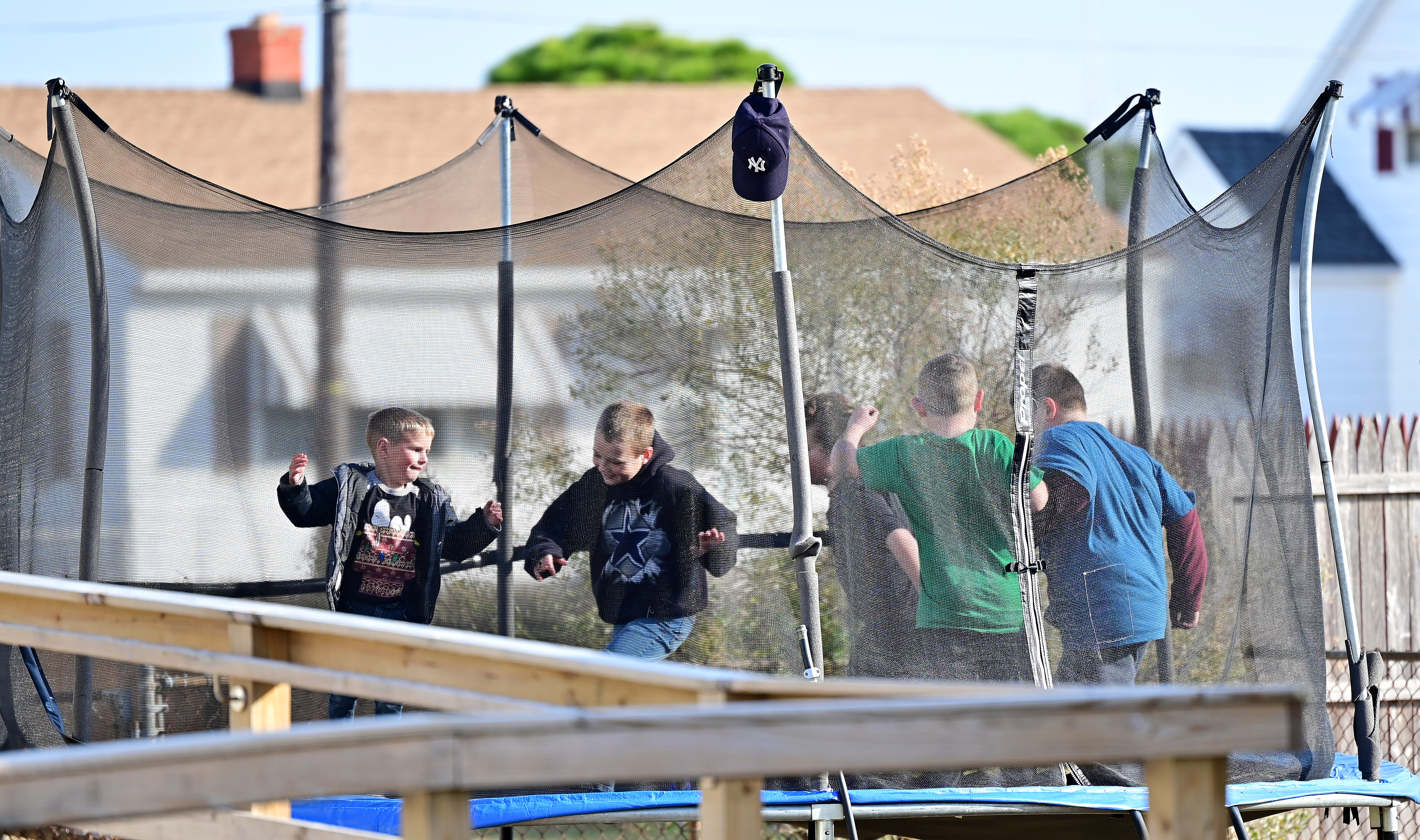Children play on a trampoline in Tangier Island, Virginia. Photo by David Tulis.                                                                                                                                                                                                               