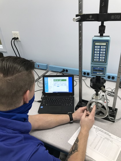 An Essco Calibration Laboratory technician tests a force gauge. Photo courtesy of Jeff Simon.