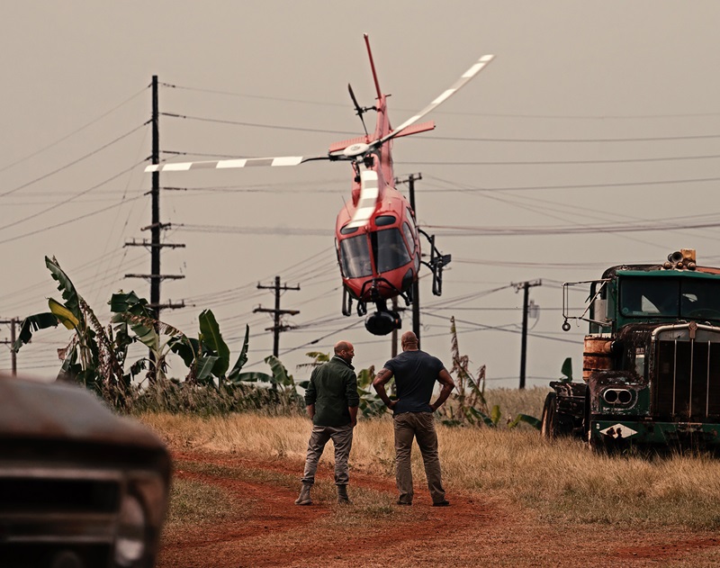 On the set of "Fast & Furious Presents: Hobbs and Shaw" in Kauai, Hawaii: After positioning his helicopter as close to the power lines in the background as possible to create space to build up speed, Fred North pitched for full speed to fly the camera low over the heads of stars Jason Statham (left) and Dwayne Johnson. The director wanted to contrast their “quiet moment” with the destruction being unleashed behind them. Photo by Daniel Smith Photography, courtesy of Fred North.