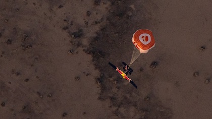 The ill-fated Cessna 182 is pictured in a vertical dive with a parachute deployed that appears smaller than parachutes used for full-airframe recovery. Video released by Red Bull shows the aircraft in a rapid vertical descent just before it hit the ground.. Photo courtesy of Red Bull Content Pool.