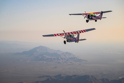 The two Cessna 182s used in Red Bull's "Plane Swap" on April 24 in Arizona. The silver aircraft (left) landed safely, while the second skydiving pilot was unable to gain entry to the blue aircraft was forced to abandon the attempt and land under his own canopy. Photo courtesy of Red Bull Content Pool.