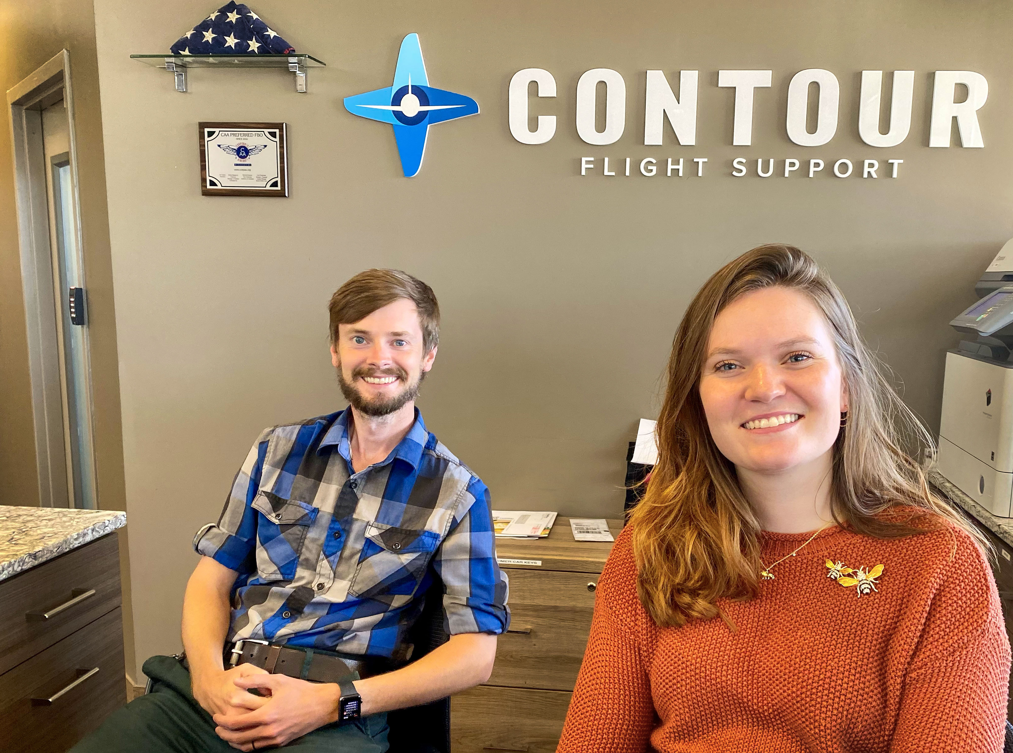 When they’re not flying or instructing, CFIs Amanda Straub and Jay Hannan greet pilots visiting the front desk of Contour Aviation at John C. Tune Airport. Photo by David Tulis.