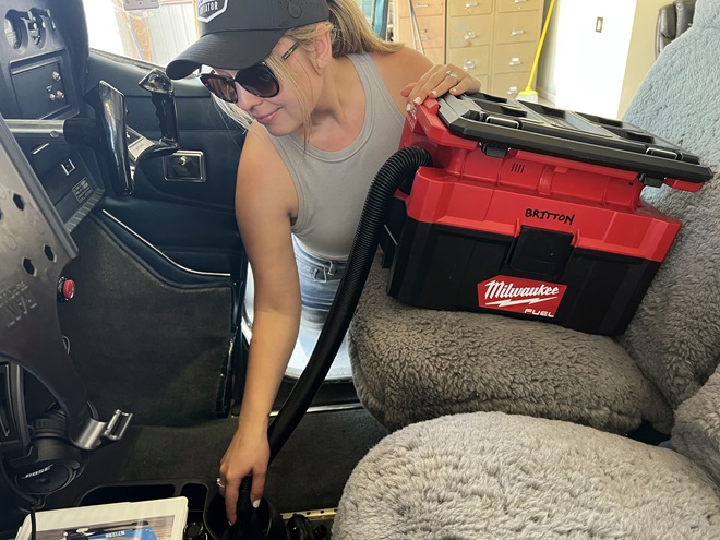 The author uses the Milwaukee wet/dry vacuum to clean the carpets and cup holders in her Cessna Skylane. Photo courtesy of Niki Britton.