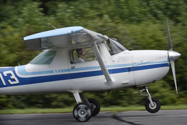 High school student Joel Cihak lifts off for his first solo flight during a Liberty University summer flight academy for six students at New London Airport in Lynchburg, Virginia. Photo by David Tulis.