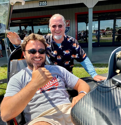 Pilot Maurizio Perissinotto, seated, is helping aerobatic aircraft designer Eddie Saurenman refine the Revo in California (when not greeting admirers at AirVenture). Photo by Dave Hirschman.