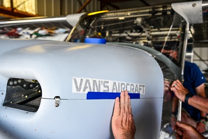 Decals are applied to the Van's Aircraft RV–15 aluminum, high-wing, tailwheel design just before the start of EAA AirVenture Oshkosh 2022. Photo by David Tulis.