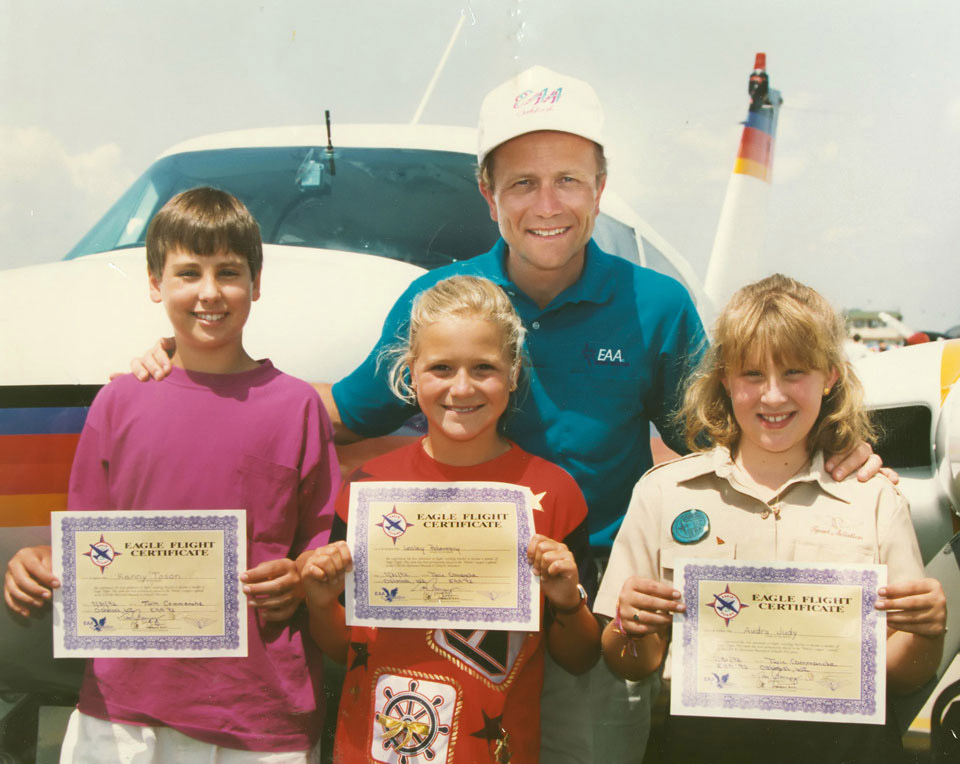 Tom Poberezny with (from left) Kenny Toson, Lesley Poberezny, and Audra Judy after the inaugural Young Eagles flights taken at Oshkosh on July 31, 1992. Photo courtesy of EAA.