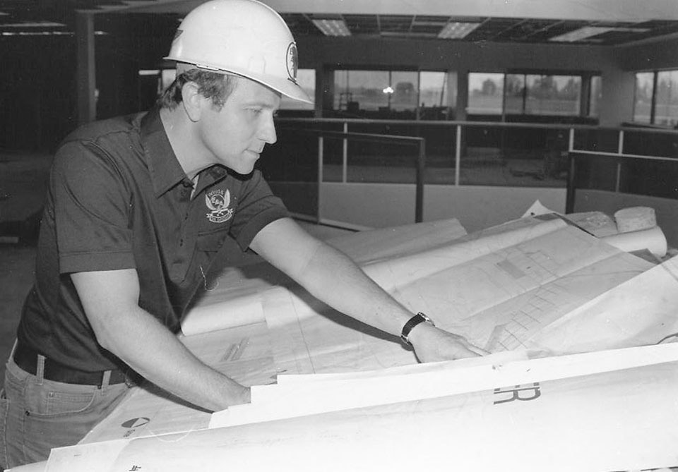 Tom Poberezny reviews the interior plans for the new EAA Aviation Center in 1983. Photo courtesy of EAA.