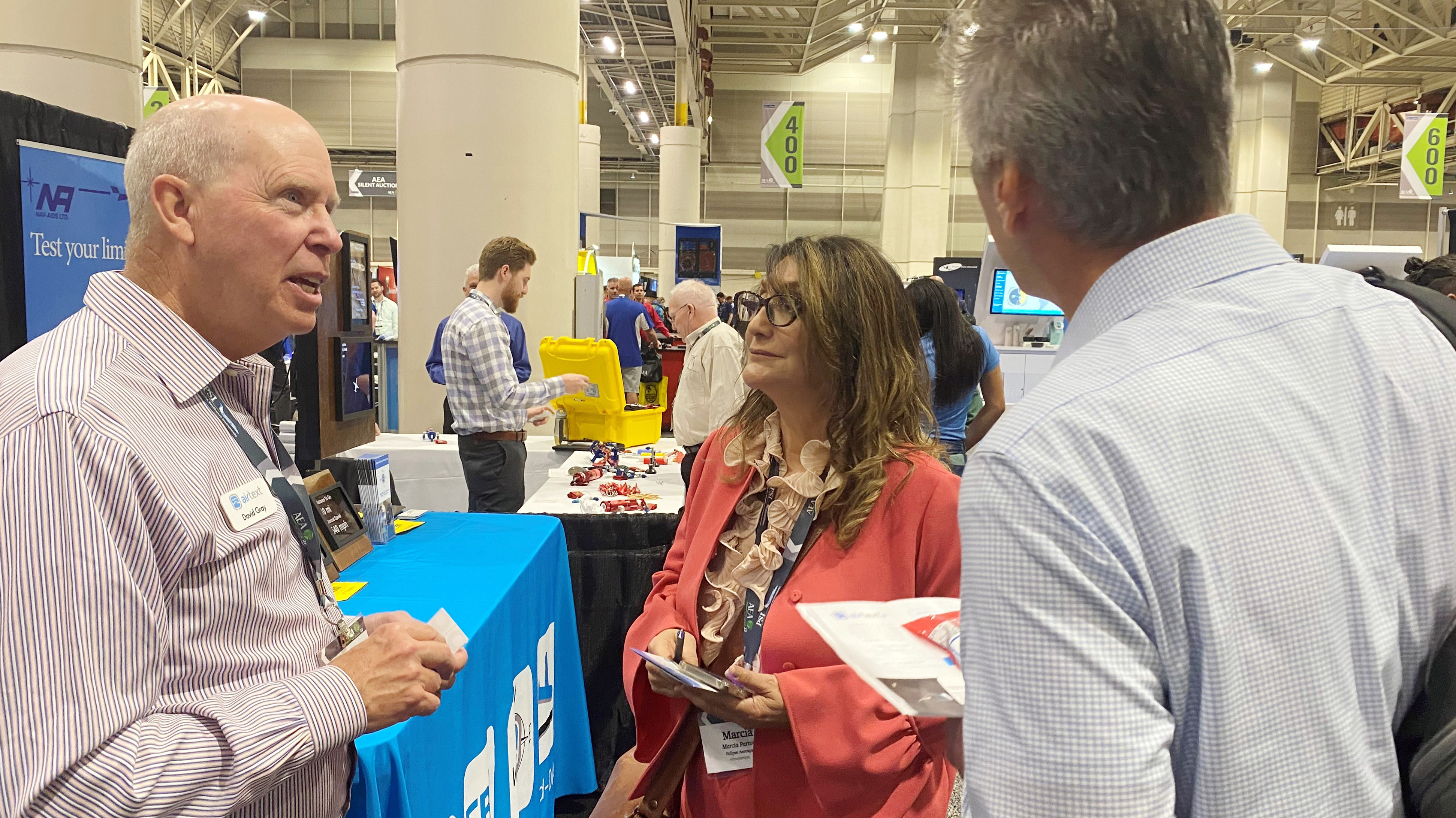 Airtext founder and CEO David Gray (left) had inventory ready to deliver, which set him apart from some exhibitors at the Aircraft Electronics Association Convention and Trade Show in New Orleans (March 28 through 31). Many manufacturers are coping with a supply chain crunch and resulting parts shortages. Gray said he acquired extra supply before the chain broke and was taking orders for prompt delivery of devices that provide satellite email, voice, and text connectivity via installed or portable devices that start just under $5,000, with services billed as they are used. Photo by Jim Moore.