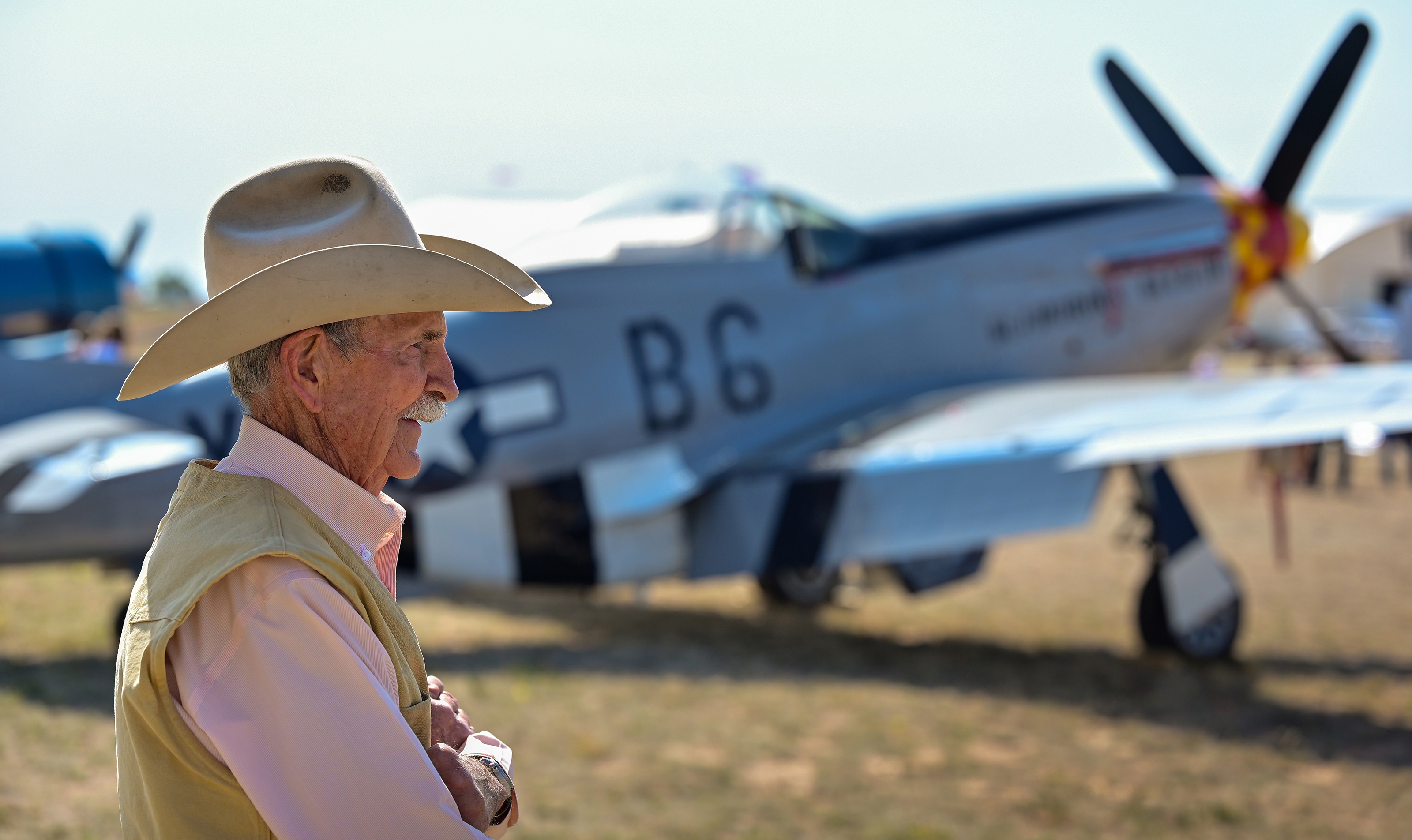 Charles Miller stands near a North American P-51 Mustang named ‘Glamorous Glen III.’  Photo by David Tulis.
