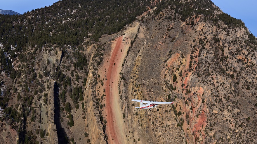 A Cessna 185 Skywagon flies near Yellowstone National Park in November. Photo by David Tulis.