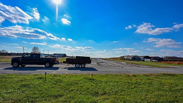 A truck hauling aircraft supplies departs from Washington Executive/Hyde Field after the owners of the facility inside the flight restricted zone announced the airport will close November 30, 2022, for redevelopment. Photo by David Tulis.