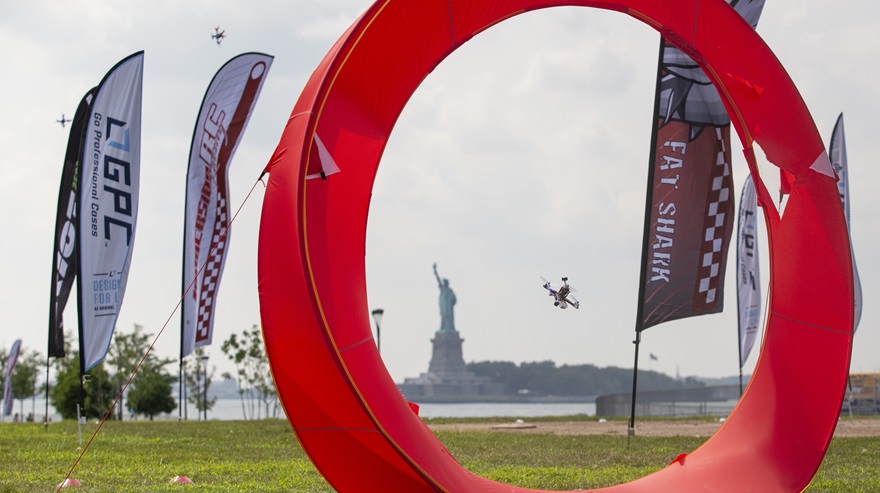 A racing drone passes through a gate at the U.S. National Drone Racing Championships in 2016. New advisory circulars published by the FAA this month enable the establishment of community-based organizations for model aircraft enthusiasts, and federal recognition of areas where aircraft like these can be flown when remote identification requirements take effect in September 2023. Photo by Jim Moore.