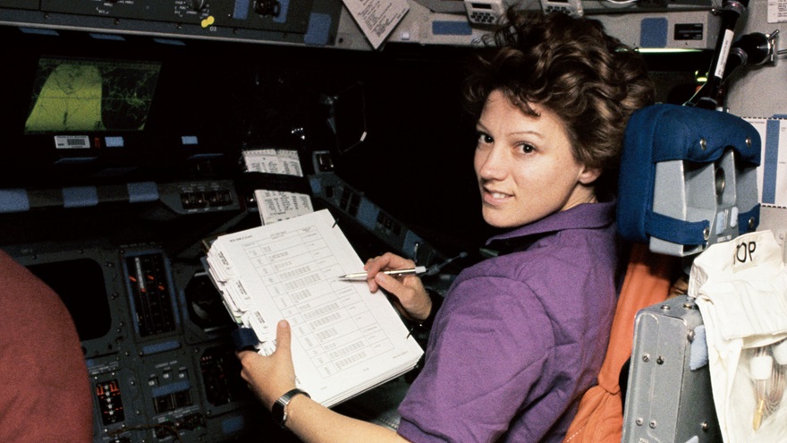 In 1995, astronaut Eileen Collins, pictured here at the pilot's station during that mission, became the first woman to pilot a space shuttle. The National Aeronautic Association named Collins, now a retired U.S. Air Force colonel, as the 2022 recipient of the Wright Brothers Memorial Trophy. NASA photo. 