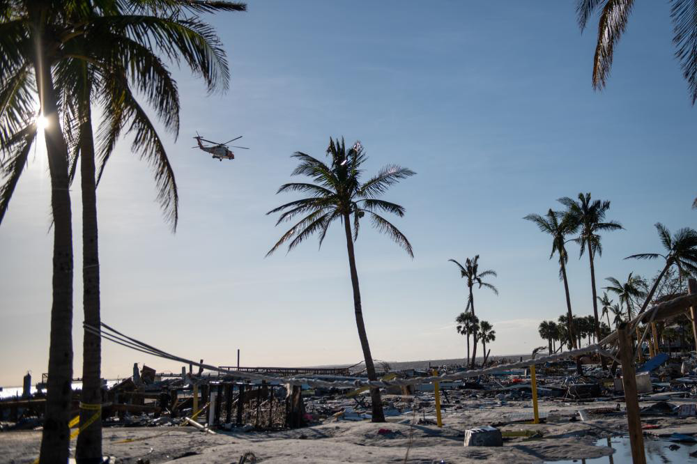 A U.S. Coast Guard Air Station Clearwater MH–60 Jayhawk aircrew scanned Fort Myers Beach, Florida, for unaccounted people on September 29. Coast Guard National Strike Force teams mobilized to areas affected by Hurricane Ian to perform urban search and rescue. U.S. Coast Guard photo by Petty Officer 3rd Class Gabriel Wisdom.