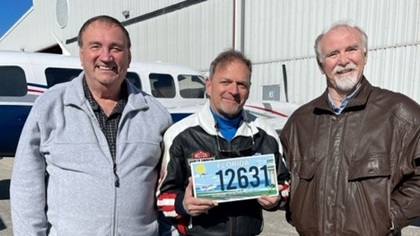 Leaders in the effort to get an aviation license plate in Florida pose with the proposed design. From left, Joseph Hurtuk, Dr. Ian Goldbaum, and Richard Golightly. Photo courtesy of Joseph Hurtuk.