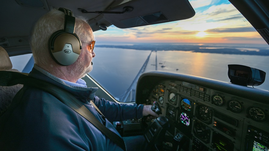 The sunrise illuminates AOPA President Mark Baker piloting a Cessna 208 Caravan to Bay Bridge Airport in Stevensville, Maryland, to begin the annual Tangier Holly Run fly-out. Baker and his wife JoAnn joined about 30 other pilots bringing fresh holiday greenery, school supplies, and other necessities to Tangier Island, Virginia, in the Chesapeake Bay on December 9. Photo by David Tulis.