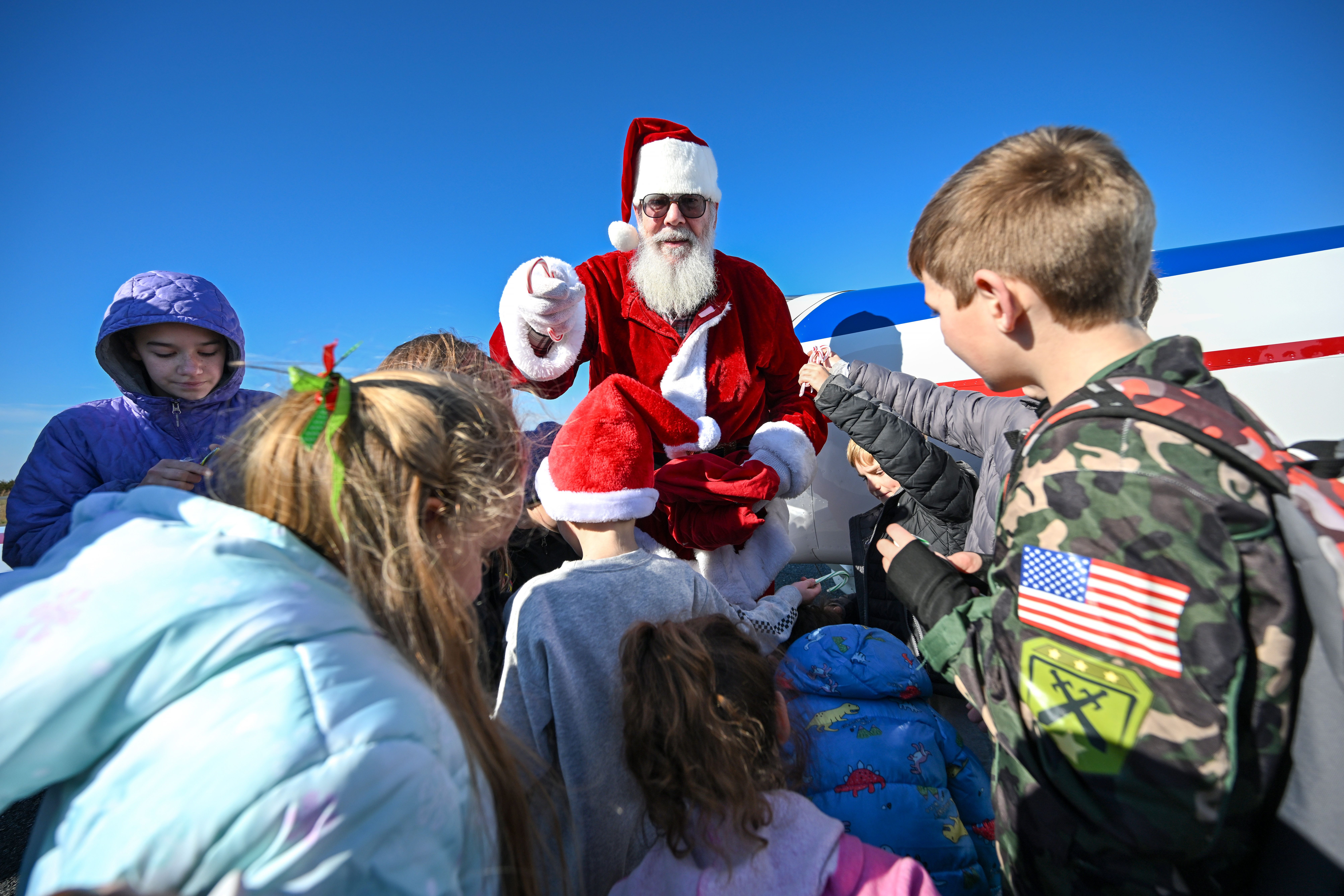 'Santa' Ralph Hoover’s Van’s Aircraft RV-7A stands in for Rudolph and the other reindeer to the delight of children living on Tangier Island. Photo by David Tulis.