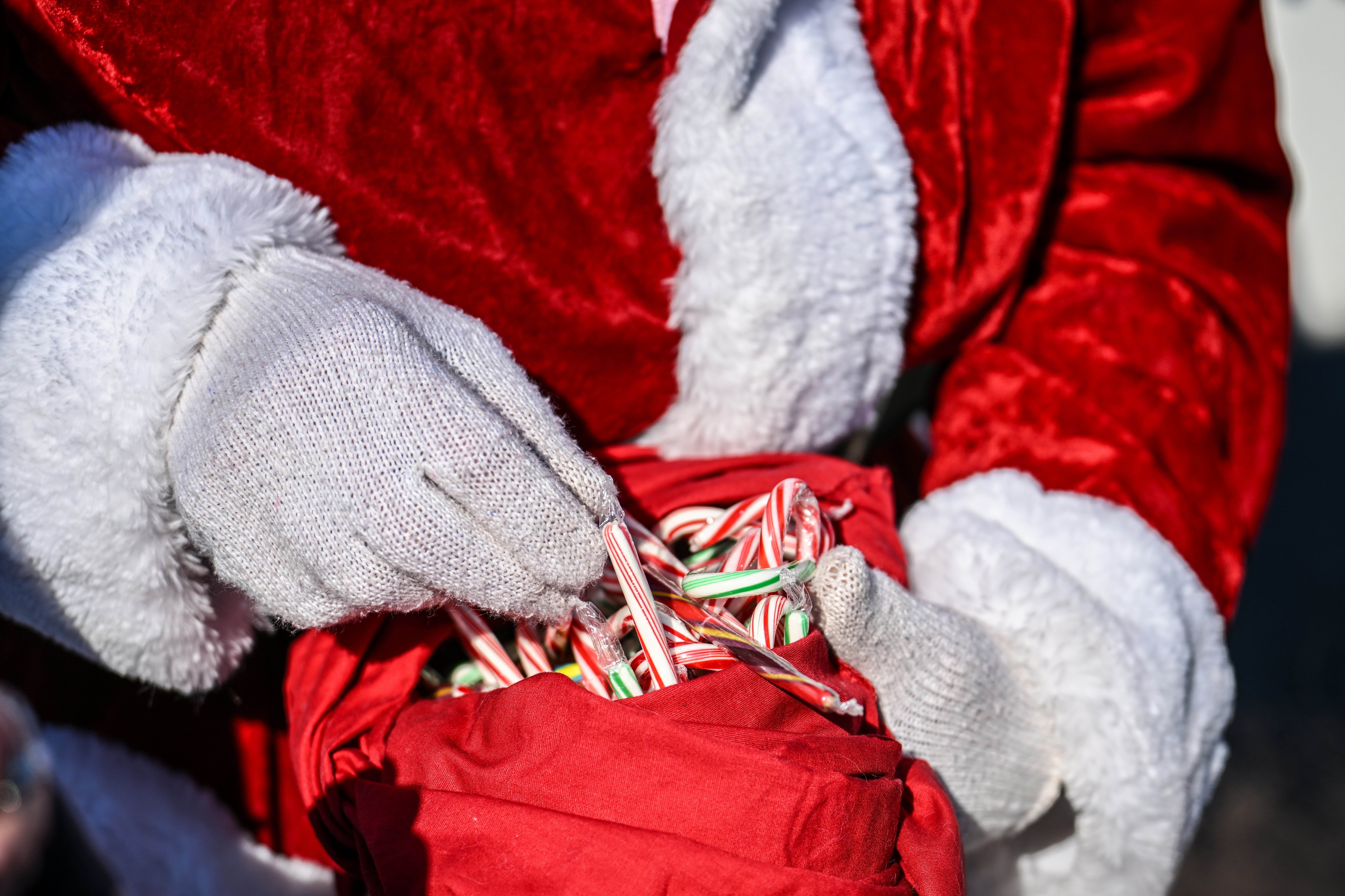 'Santa' Ralph Hoover hands out candy canes to children. Photo by David Tulis.
