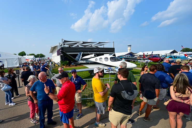 Attendees line up for a Cirrus Aviation kickoff party during EAA AirVenture Oshkosh at Wittman Regional Airport. Photo by David Tulis.