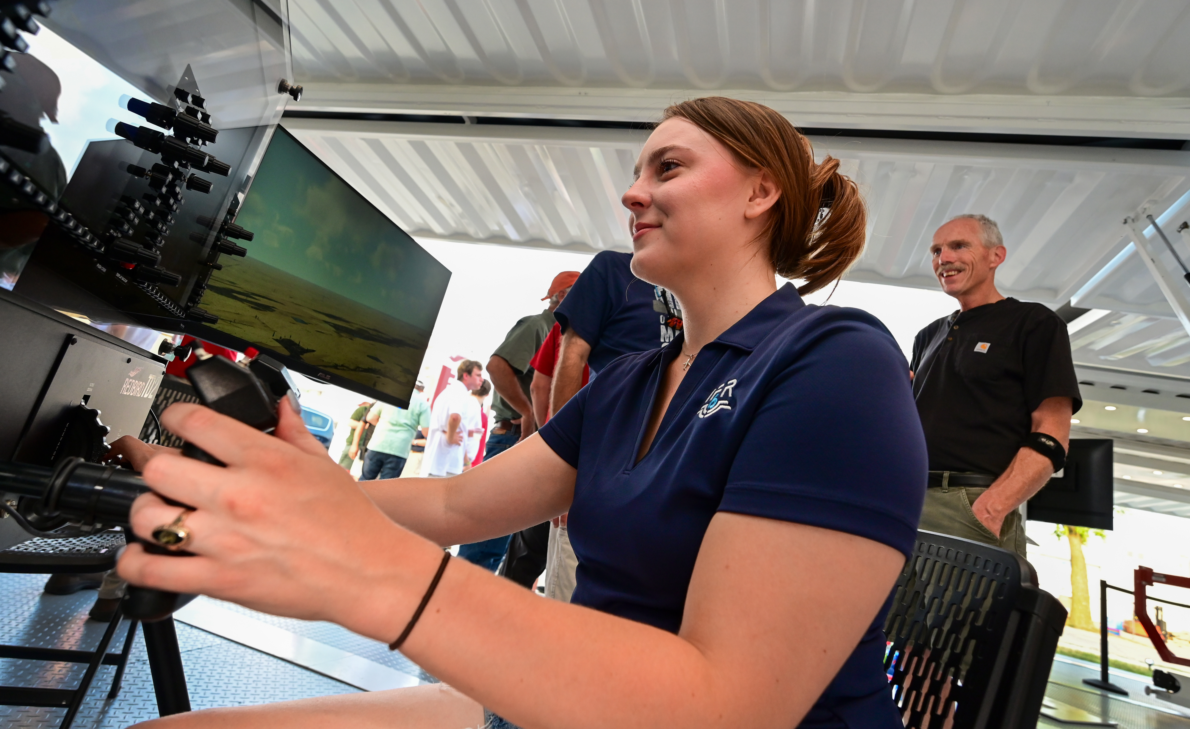 Sarah Canterbury of Charleston, South Carolina, concentrates on flying a Redbird simulator at a kickoff event during EAA AirVenture Oshkosh. Photo by David Tulis.
