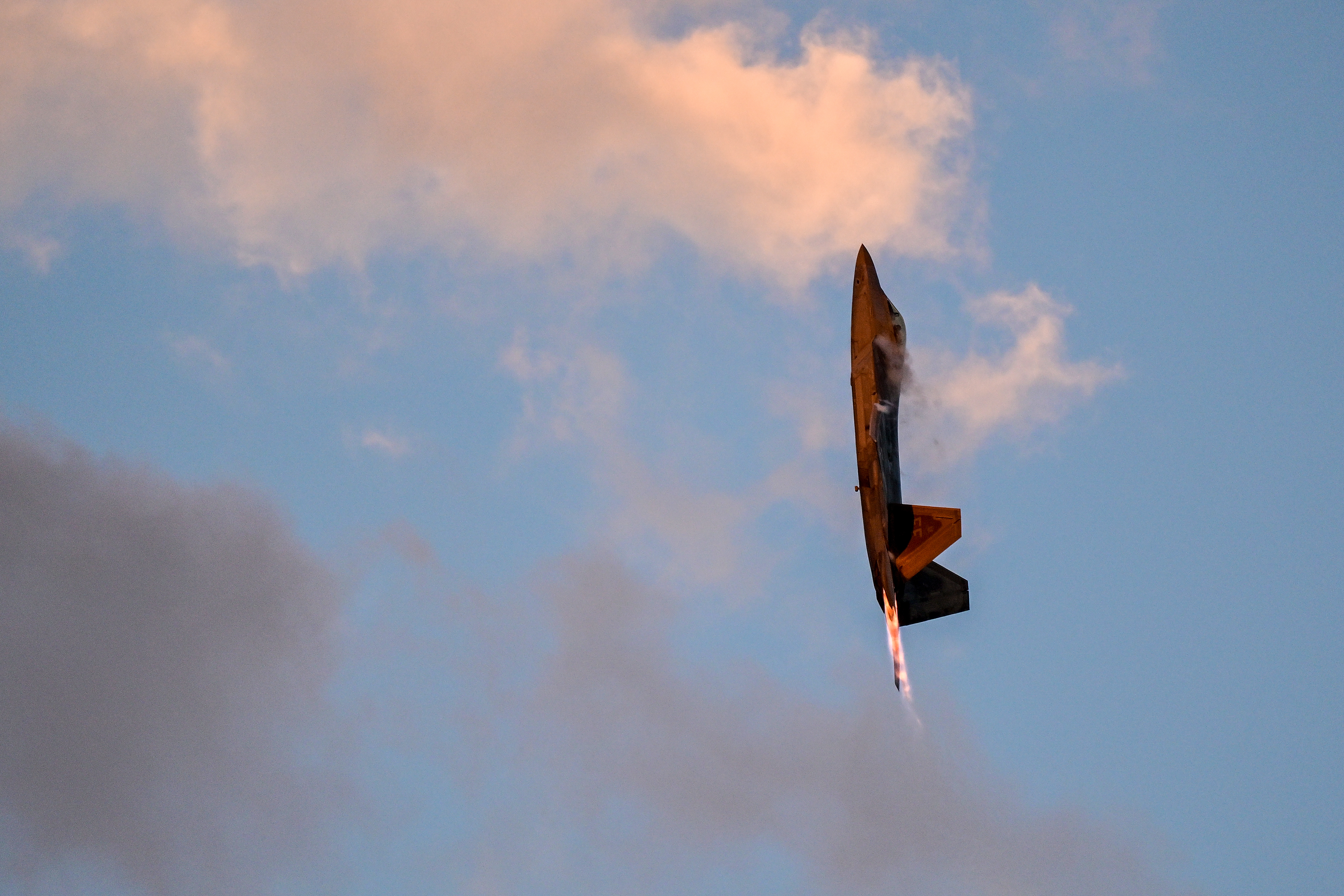 A U.S. Air Force Lockheed Martin F-22 Raptor flies vertically during the Saturday night airshow. Photo by David Tulis.