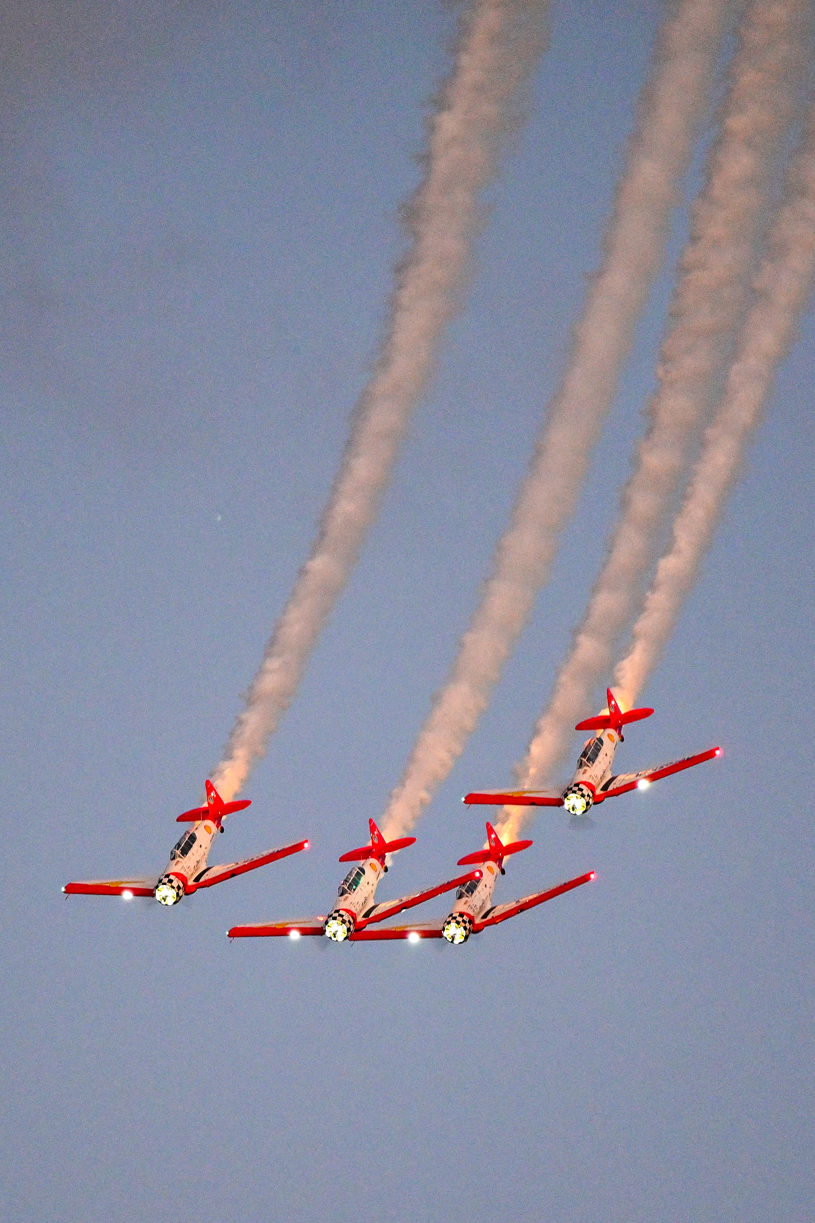 The AeroShell Aerobatic Team loops in formation. Photo by David Tulis.